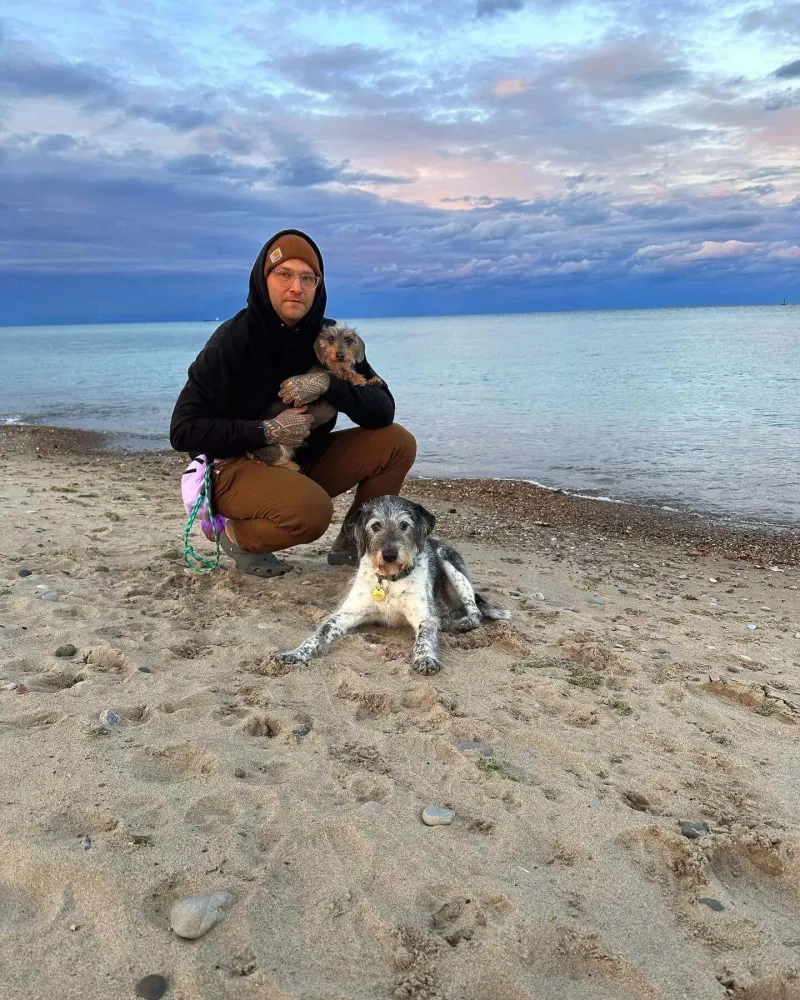 Kevin Diesenberg with his dogs enjoying a sunny day by Lake Huron